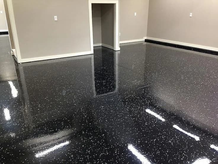 Black metallic epoxy floor with a high-gloss reflection
