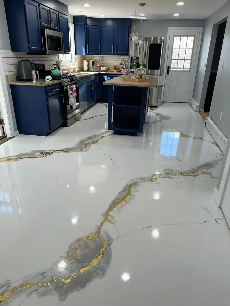 Metallic epoxy floor with marble-like veining in a kitchen