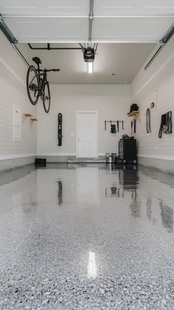 Clean domestic garage with a light grey resin floor
