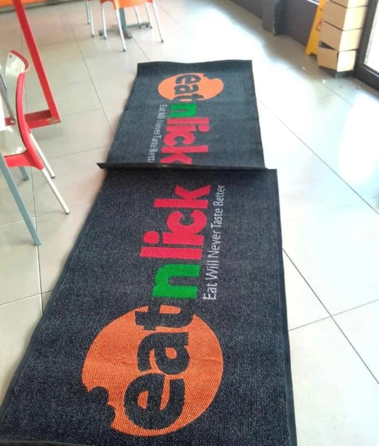 Eat 'n' Lick branded entrance runner inside a retail outlet