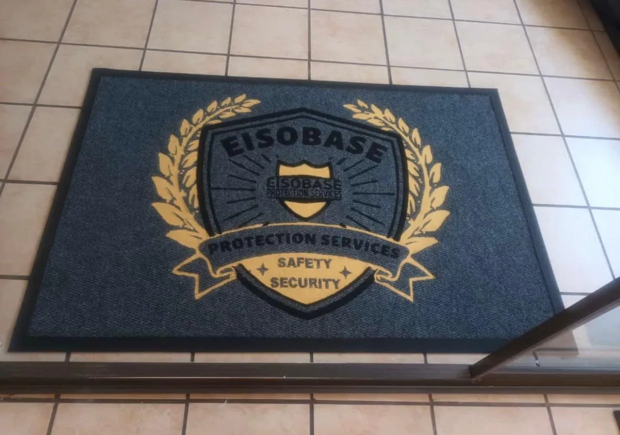Branded mat reproducing a detailed gold company crest
