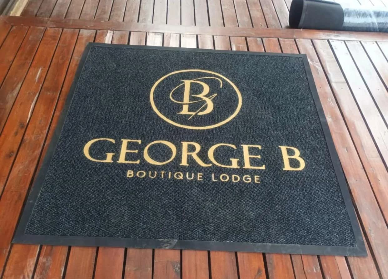 Boutique lodge entrance mat with a gold monogram
