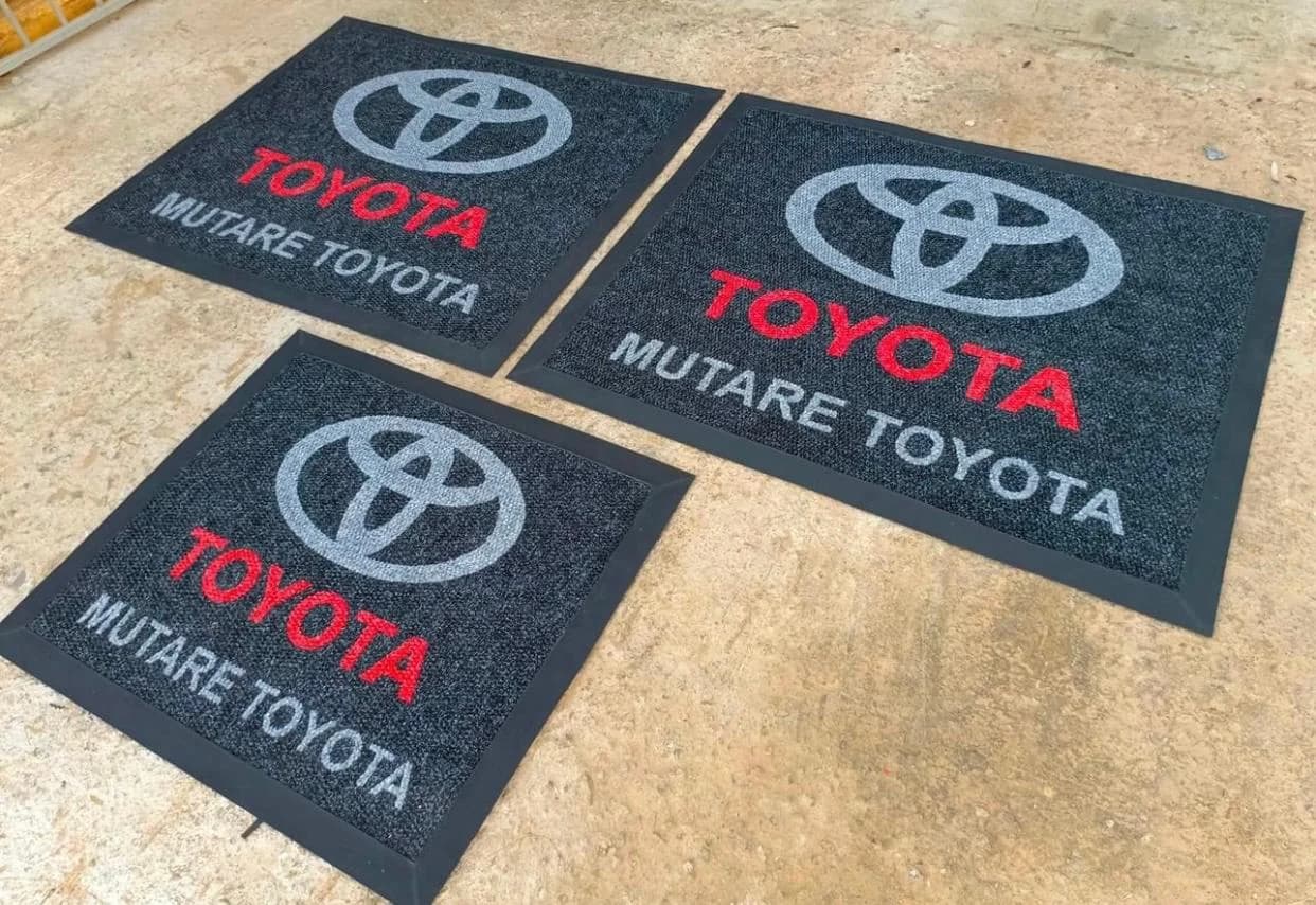 Three Mutare Toyota branded mats laid out on a forecourt