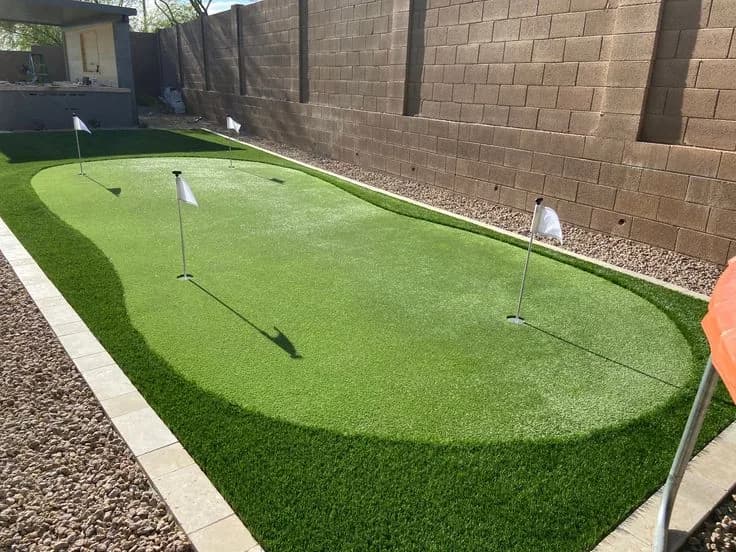 Two-hole putting green laid alongside a gravel border