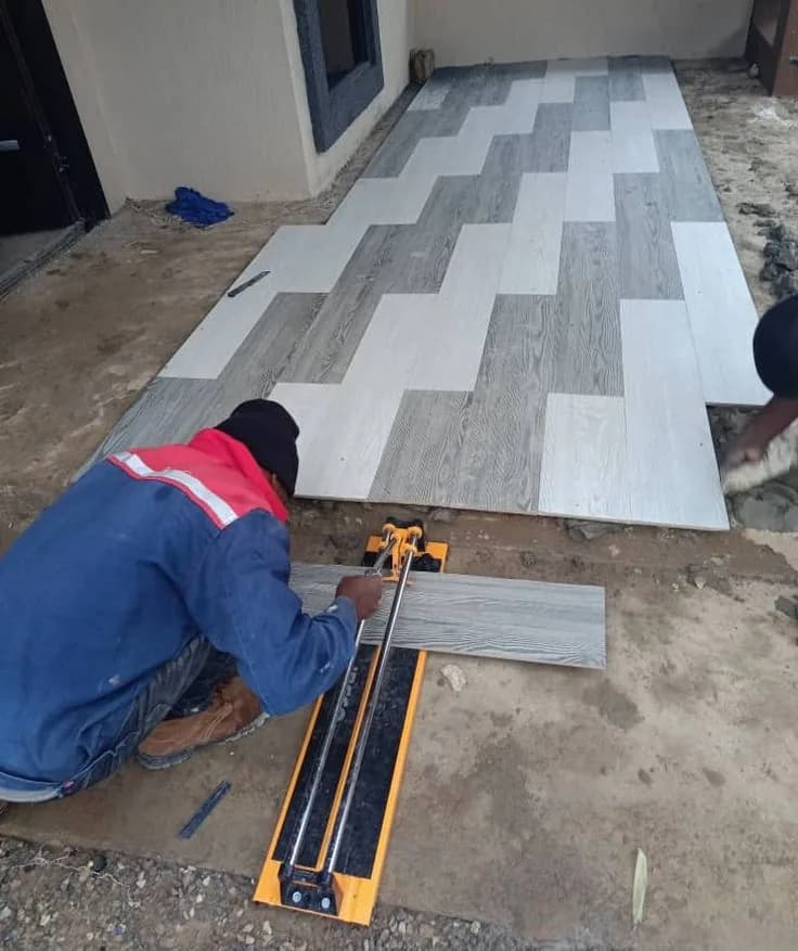 Installer cutting a vinyl plank to length on site