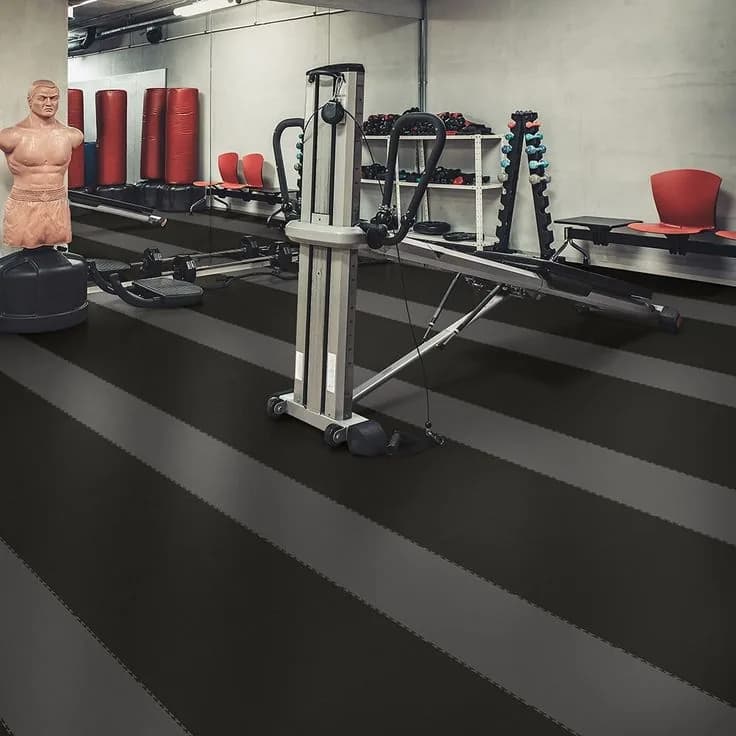 Fitness studio with dark rubber flooring and training equipment