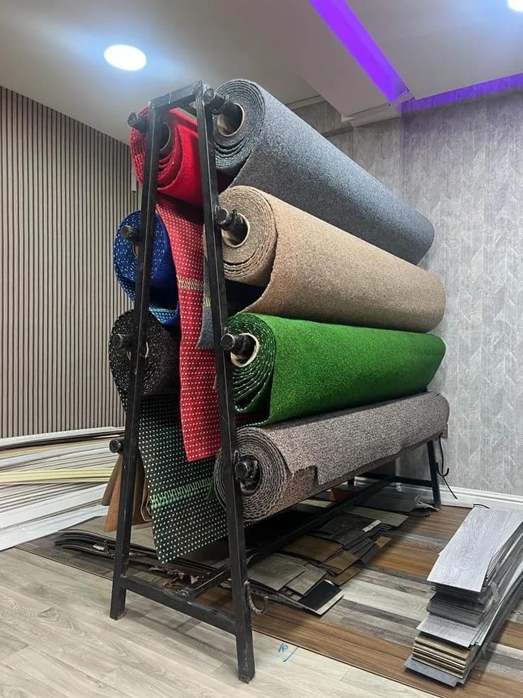 Rolls of flooring material stacked on a rack in a showroom